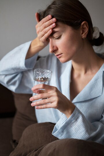 a lady getting hydrated as one of the home remedies for migraines