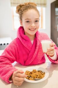 a kid enjoying one of the best snacks for kids